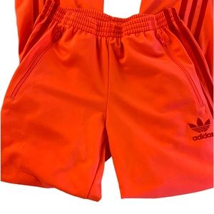 Adidas Orange track pants with dark orange 3 stripes side pickets with zippers